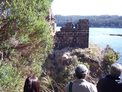 Visitors look over the ruin on Sarah Island near Strahan Tasmania